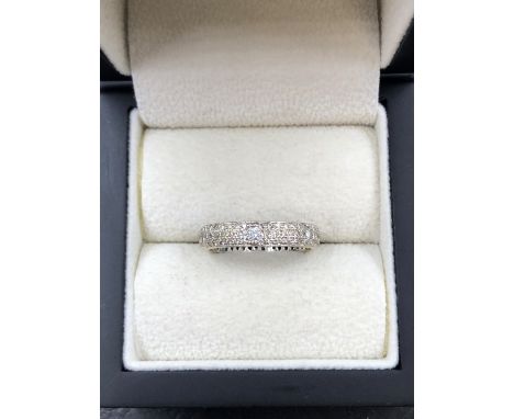 A FULL DIAMOND SET WEDDING BAND TYPE RING. UNHALLMARKED, ASSESSED AS 18ct GOLD. FINGER SIZE P 1/2. WEIGHT 3.27grms. 