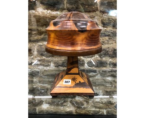 AN EXOTIC WOOD MARQUETRY TABLE LAMP, THE SQUARE SECTIONED BASE WORKED WITH PALME AND OTHER TREES ON SHORE LINES, THE SHADE OF