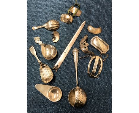 FOUR SILVER TEA CADDY SPOONS, SEVEN SILVER BOTTLE LABELS, A SILVER FOX HEADED BOOK MARKER AND A SILVER STRAINING SPOON, 177.2