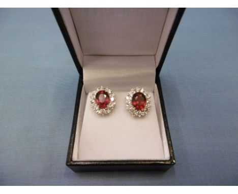 A pair of 18ct white gold treated ruby and diamond cluster stud earrings, total carat weight 5.13ct, total diamond weight 1.7