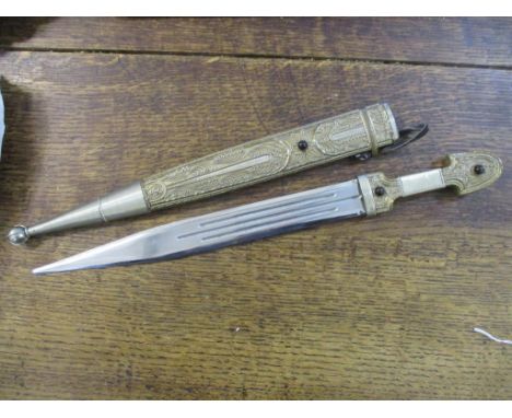 A Georgian Kindjal dagger with filigree decorated handle and scabbard set with three cabochon garnets, the blade with triple 
