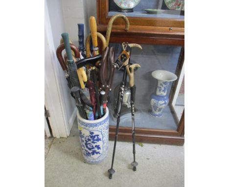 A modern Oriental blue and white porcelain stick stand containing various umbrella, ski poles and walking sticksLocation: 