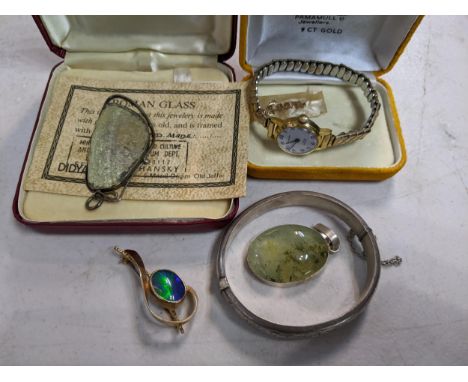 A small collection of jewellery to include a yellow metal and opal brooch, 5.7g, a silver bangleLocation: 