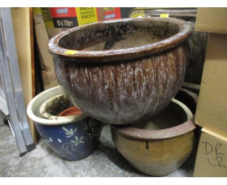 A selection of terracotta and other garden planters of various size to include a large white drip over brown glazed planter, 
