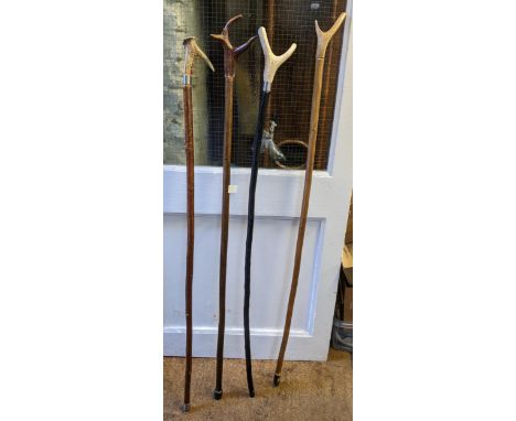 A selection of hiking stag horn thumb stick walking canes 