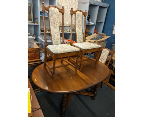 A vintage Ercol elm extending dining table 73cm h x 162cm w unextended, and a set of six dining chairs Location: 