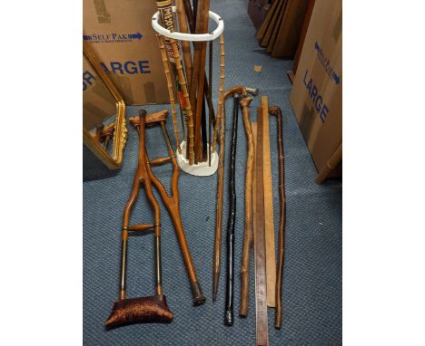 Artis cast and bamboo iron walking stick stand with a walking sticks and a pair of Victorian childs crutches 