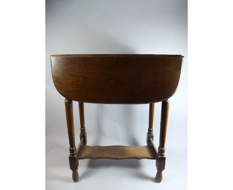 An Oak Drop Leaf Occasional Table with Stretcher Shelf on Turned Supports, 61cm Wide