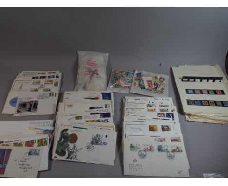 A Box of One Hundred and Thirty First Day Covers and Several Packs of Loose Stamps 