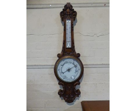 A Late Victorian Carved Oak Wheel Barometer with Temperature Scale, 84cm high