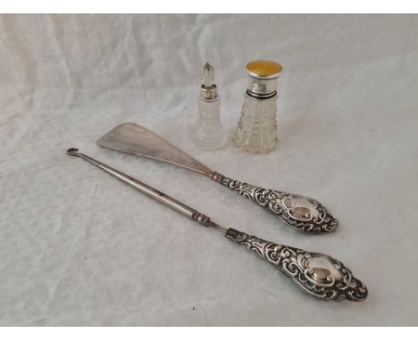 A enamel top scent bottle, another scent bottle with glass body also plus button hook and shoe horn