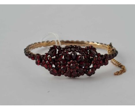 Antique Victorian Bohemian garnet set bangle with stylized flower motif