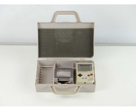 Nintendo Gameboy handheld games console in a hard plastic Gameboy travel case together with Light Magic screen magnifier (1 i
