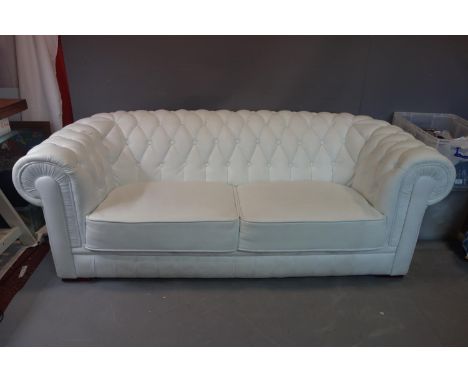 A three seat Chesterfield sofa in white buttoned faux leather upholstery, H72, W198cm, D91cm.