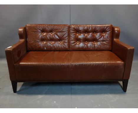 A brown leather 2 seater sofa, with button back cushions, on tapered legs, H.80 W.153 D.73cm, wear to leather 