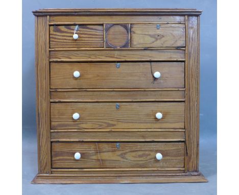 A pine table top chest, with two short over two long drawers, having ceramic handles (one missing), H.50 W.51 D.24cm 