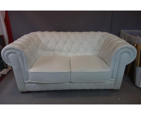 A two seater Chesterfield sofa upholstered in faux white leather, H72cm, W160cm,D90cm