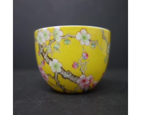 A Chinese famille rose Yongzheng style teacup, decorated Chinese inscription and cherry blossoms on a yellow ground, bearing 