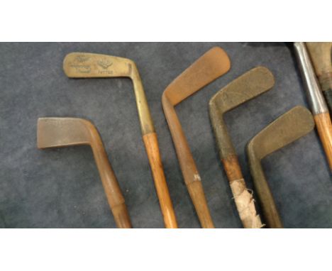 A collection of smooth face irons,including a group stamped Army & Navy comprising a putter, 2 irons and socket head wood cir