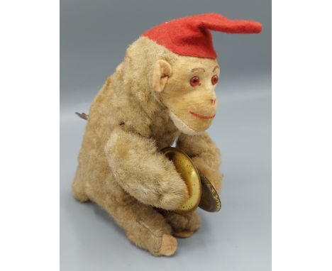 A plush wind up monkey with cymbals, 19cms tall