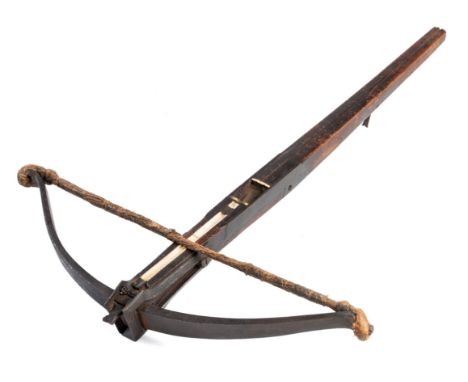 A RARE CROSSBOW, EARLY 17TH CENTURY, ENGLISH OR SPANISH with robust steel bow retained by a pair of moulded irons, fitted wit