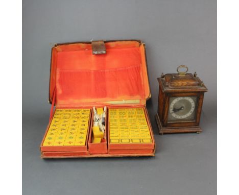 A leather cased Mahjong set together with an oak mantle clock with replacement battery movement.