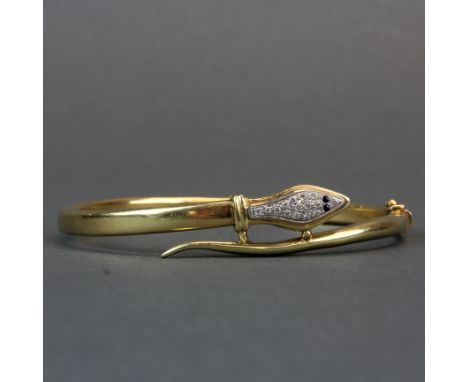 A 14ct gold diamond set snake hinged bangle, W. 7cm. (partial stamp and tested)