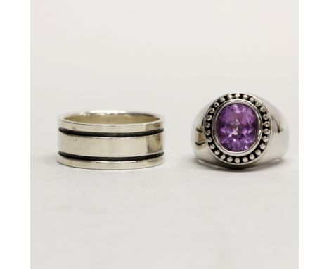 A heavy silver amethyst ring together with a further silver ring.