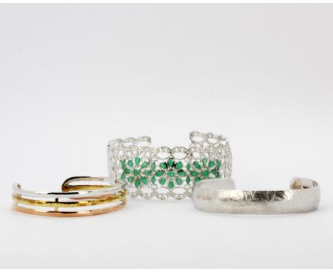 A 925 silver and emerald bangle, together with a 925 silver bangle and a 925 silver and silver gilt tri-colour bangle.