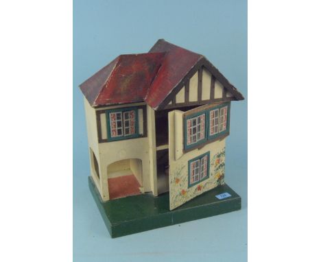 A small hand painted and decorated vintage dolls house, 41.5cm high (signs of age)