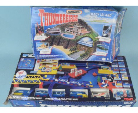 A c1990's boxed Thunderbirds Tracy Island together with a 'Tomy Train 4' model train set