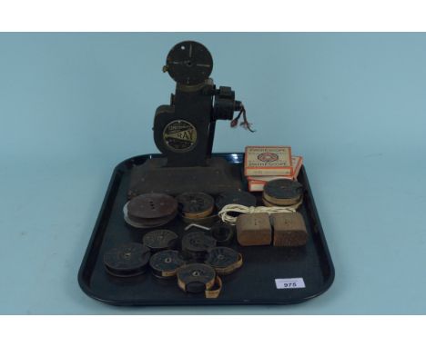 A 'Construments Ray' 9.5mm vintage cine camera with pathescope spare reels with Charlie Chaplin and Betty Boop films