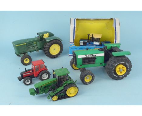A vintage Tonka XMB 975 tractor together with a John Deere tin plate tractor 8330T, a Britains 1986 small tractor and a boxed
