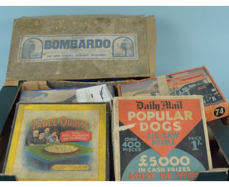 A box of vintage games and jigsaw puzzles including Peall's Bombardo Pool, made by disabled soldiers and sailors