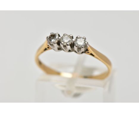 A YELLOW METAL THREE STONE DIAMOND RING, three round brilliant cut diamonds, shared claw setting, stamped diamond weight 0.33