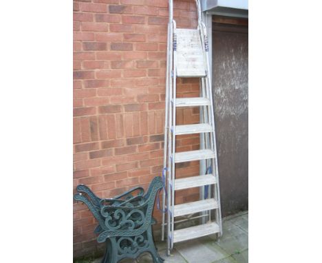 TWO PAIRS OF GREEN PAINTED CAST IRON BENCH ENDS together with a set of step ladders, height 241cm