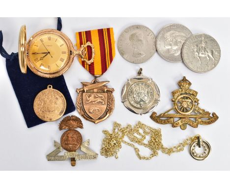 A BAG OF ASSORTED ITEMS, to include a novelty 'Timex' pocket watch, three commemorative coins, three various medals one fitte