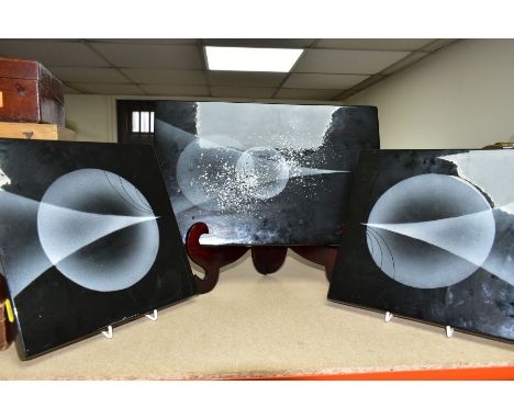 THREE ALAN CLARKE WALL PLAQUES, with a black and grey abstract design of circles and triangles, comprising a pair of 26cm squ