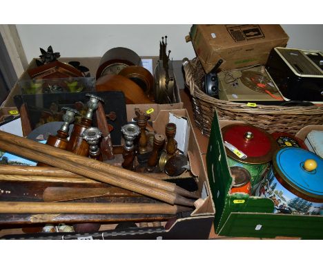 THREE BOXES AND A WICKER BASKET OF CLOCKS, TINS, TREEN CANDLESTICKS, CRICKETING EQUIPMENT, ETC, including vintage cricket bat