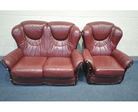 A BURGANDY LEATHER TWO PIECE LOUNGE SUITE, comprising a two seater sofa and an armchair (condition:-cracking to arms on armch