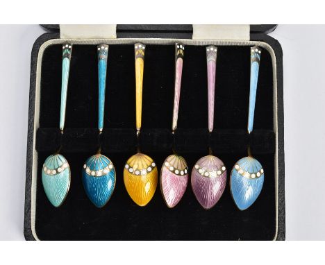 A CASED SET OF SIX HARLEQUIN ENAMELLED TEASPOONS, six spoons each with a different coloured guilloche enamel, encased in thei