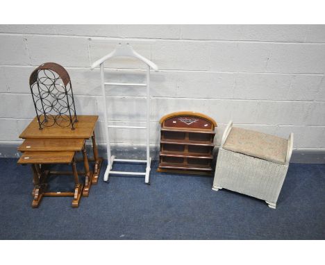 AN OAK NEST OF THREE TABLES, a painted valet stand, a Lloyd loom linen basket, a mahogany collected display shelf and a wine 