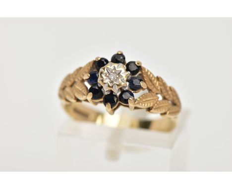 A 9CT GOLD SAPPHIRE AND DIAMOND CLUSTER RING, the cluster of a flower shape, set with a central illusion set single cut diamo