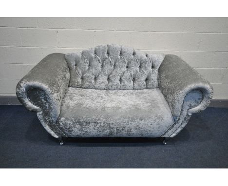 A SILVER VELVET STYLE BUTTONBACK SOFA, on chromed legs, length 183cm x inner length 110cm (this sofa has no fire labels, but 