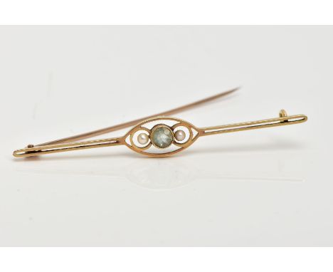 A YELLOW METAL BAR BROOCH, centring on a circular cut aquamarine, flanked with seed pearls, within an openwork marquise shape