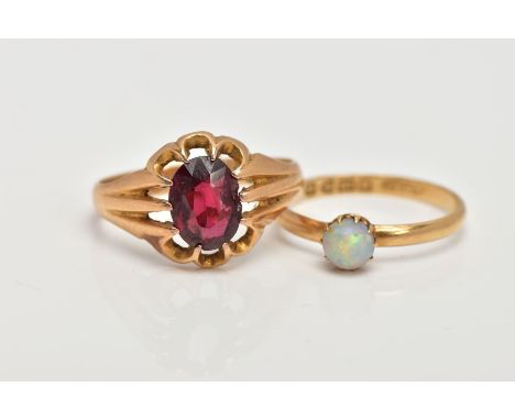 TWO 18CT GOLD RINGS, the first designed with a ten claw set, oval cut garnet (damaged), scallop surround, tapered shoulders, 