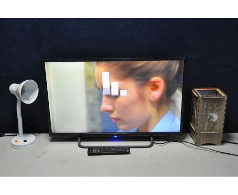 A TECHNIKA 32G22B-HD TV along with two lamps a white flexi lamp and a Chinese lantern style lamp (all PAT pass and working) (