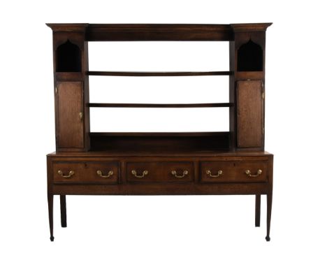 An 18th century oak dresser and rackThe rack with breakfront cornice above three shelves flanked by niches and cross-banded s