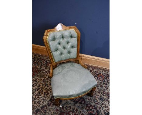 A Victorian inlaid walnut button upholstered lady's chair on turned supports.
