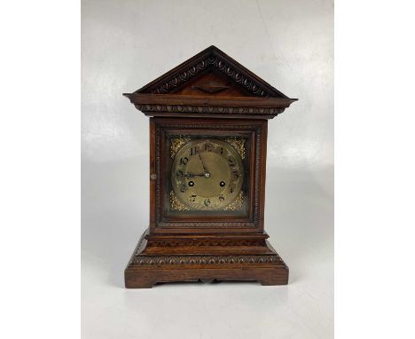 An oak cased 20th century mantel clock, with brass dial set with Arabic numerals, height 38cm.